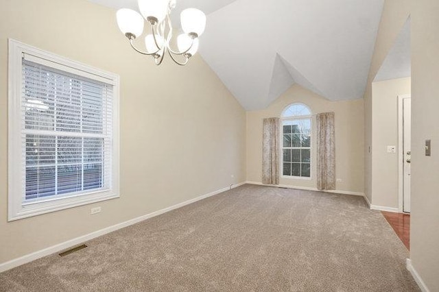 spare room featuring baseboards, visible vents, lofted ceiling, an inviting chandelier, and carpet flooring