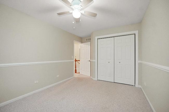 unfurnished bedroom with carpet, a closet, visible vents, and baseboards