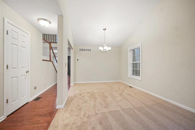 interior space with a chandelier, visible vents, stairway, and baseboards