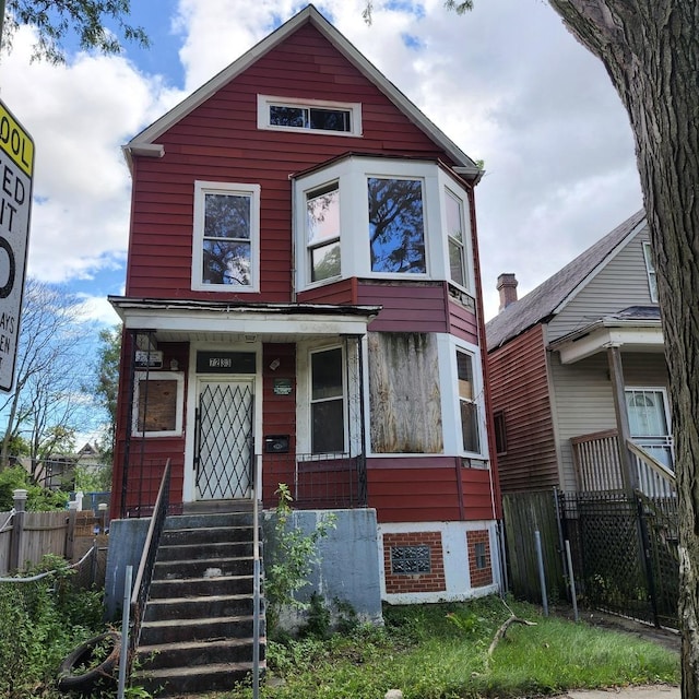 view of front of home featuring fence