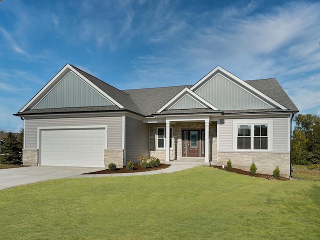 craftsman house featuring driveway, stone siding, an attached garage, and a front lawn