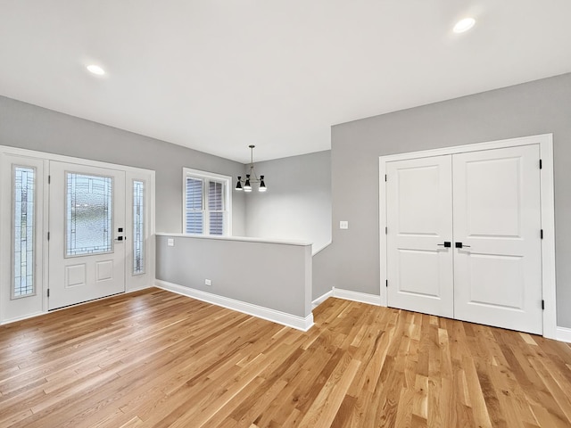 entryway with light wood-type flooring, baseboards, a chandelier, and recessed lighting