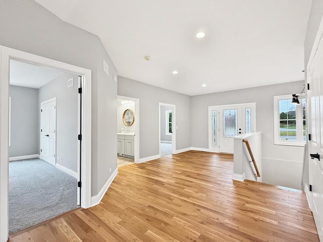 interior space featuring recessed lighting, visible vents, light wood-style flooring, and baseboards