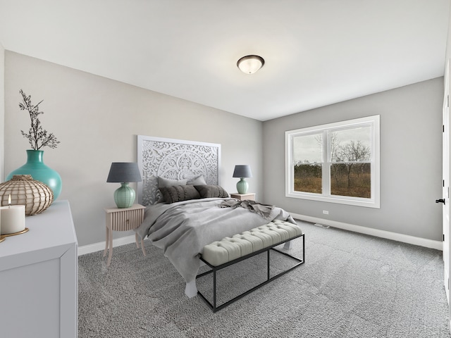 bedroom with carpet floors, visible vents, and baseboards