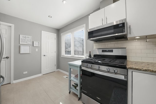 kitchen featuring tasteful backsplash, baseboards, recessed lighting, stainless steel appliances, and white cabinetry