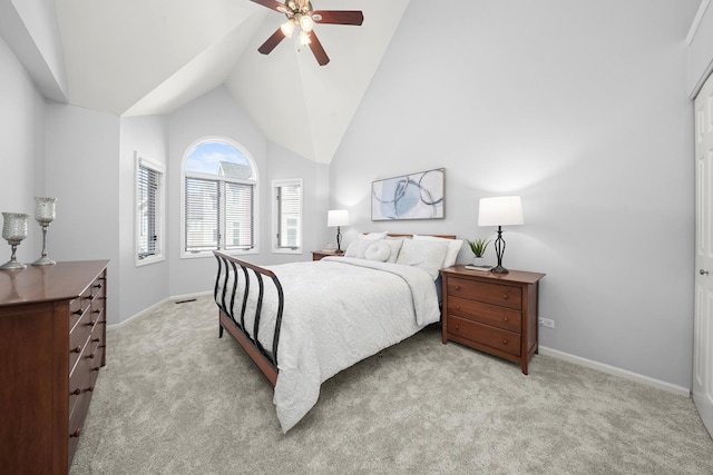 carpeted bedroom with ceiling fan, baseboards, and high vaulted ceiling