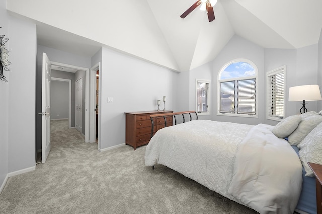 bedroom featuring light carpet, high vaulted ceiling, a ceiling fan, and baseboards