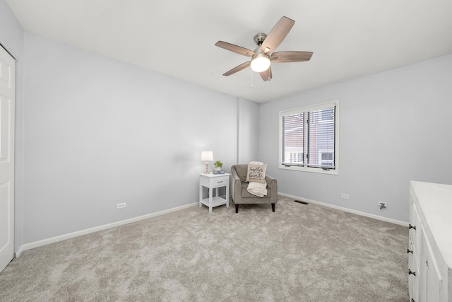 unfurnished room featuring ceiling fan, light colored carpet, visible vents, and baseboards