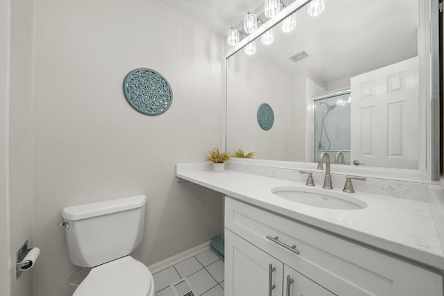 bathroom featuring vanity, baseboards, visible vents, a shower stall, and toilet