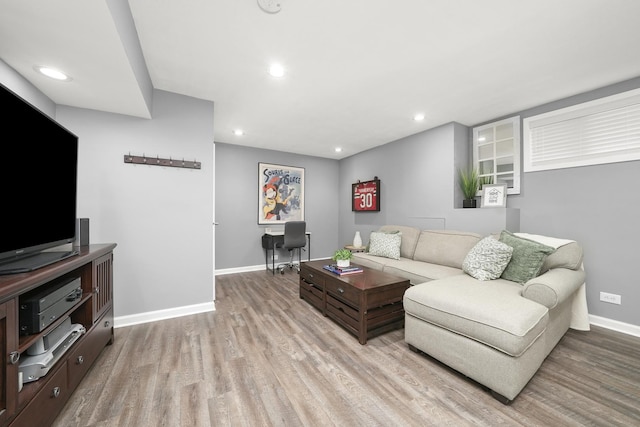 living room with recessed lighting, light wood-type flooring, and baseboards