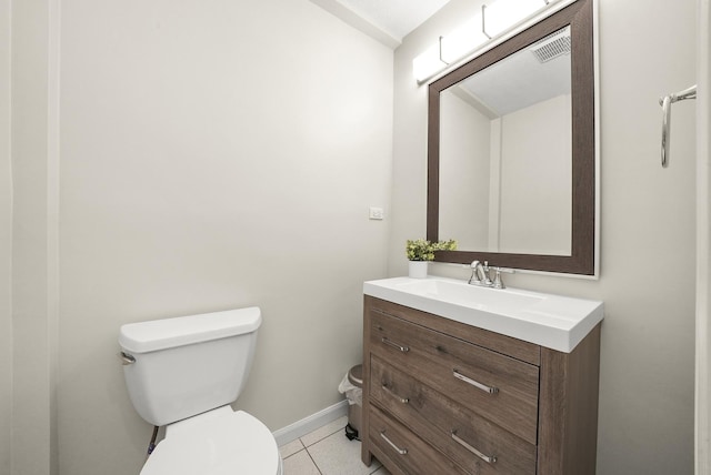 bathroom featuring vanity, baseboards, visible vents, tile patterned floors, and toilet