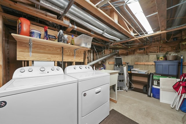 laundry room featuring a sink, washing machine and dryer, and laundry area