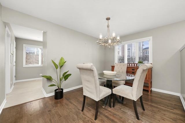 dining room featuring plenty of natural light, baseboards, and wood finished floors