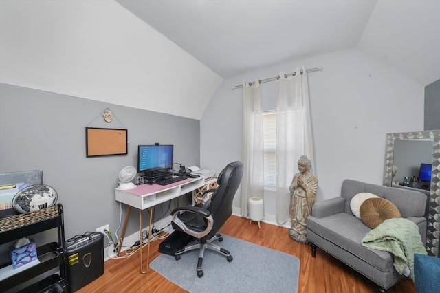 office area featuring vaulted ceiling, baseboards, and wood finished floors