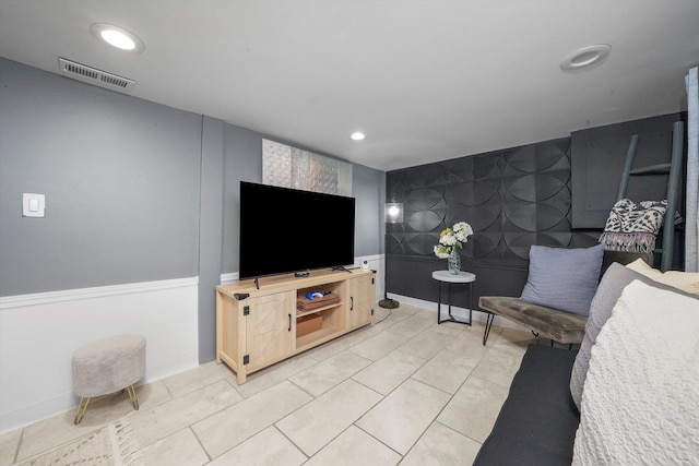 living area featuring recessed lighting, a wainscoted wall, visible vents, and light tile patterned floors