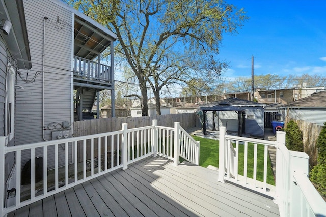 wooden terrace with a gazebo, a fenced backyard, and a yard