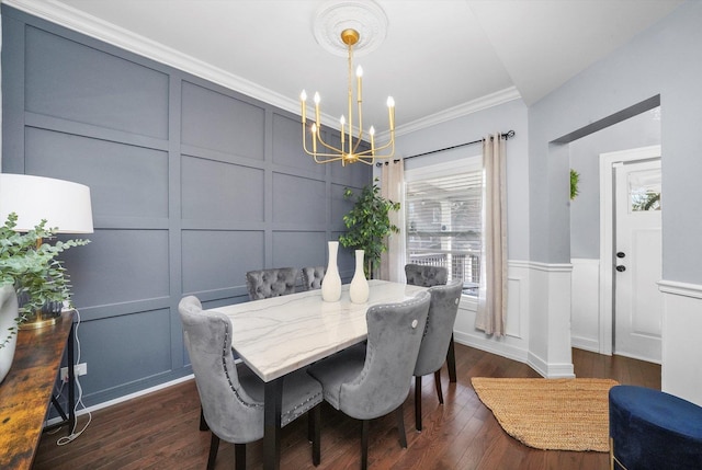 dining room with an inviting chandelier, crown molding, a decorative wall, and dark wood-style flooring