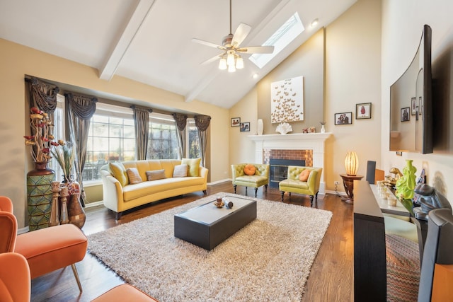 living room featuring a skylight, a brick fireplace, ceiling fan, wood finished floors, and high vaulted ceiling