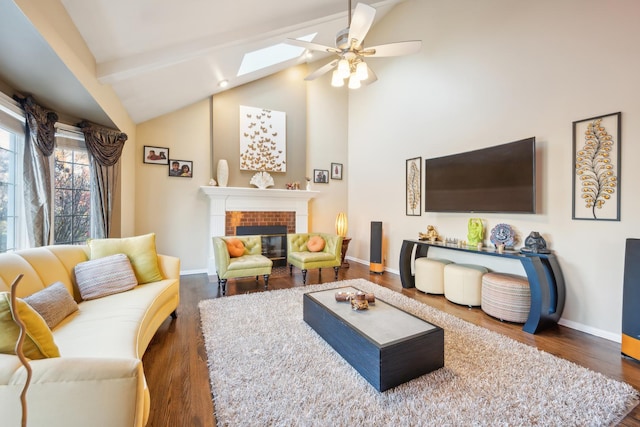 living room with lofted ceiling with skylight, a fireplace, baseboards, and wood finished floors