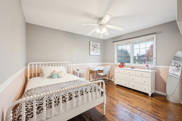 bedroom with a ceiling fan, baseboards, and wood finished floors