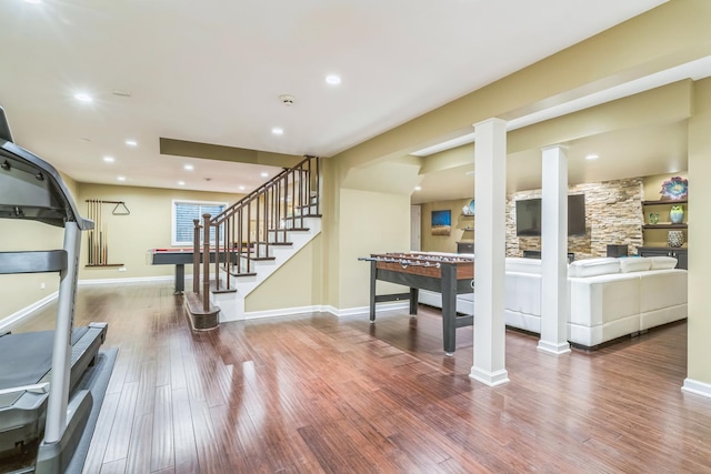 recreation room with recessed lighting, wood finished floors, decorative columns, and baseboards