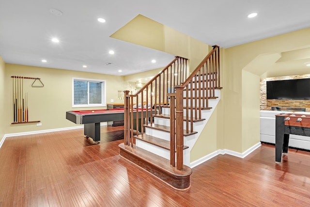 stairs with recessed lighting, baseboards, and wood finished floors