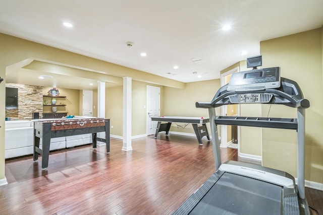 workout area featuring baseboards, wood finished floors, and recessed lighting