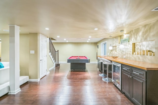 recreation room featuring dark wood-type flooring, wine cooler, a bar, and recessed lighting