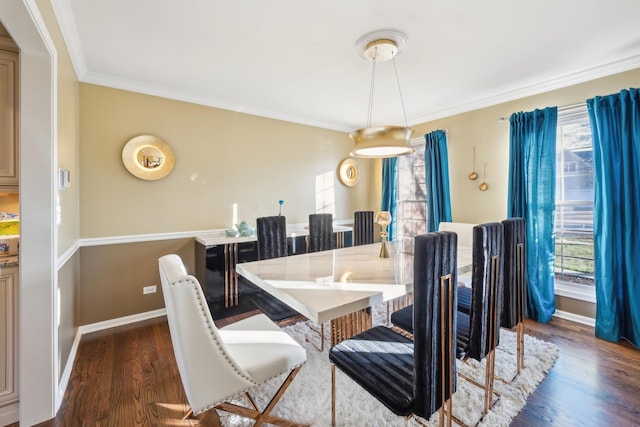 dining room with a wealth of natural light, dark wood-style flooring, crown molding, and baseboards