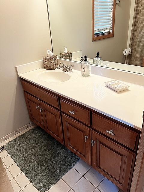 bathroom with tile patterned flooring and vanity