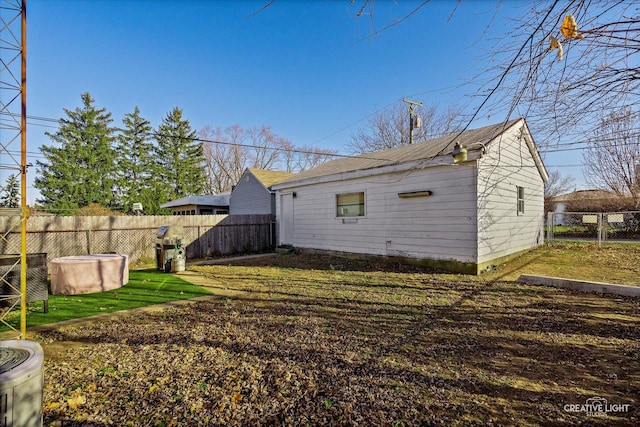 exterior space with a fenced backyard, an outbuilding, and a yard