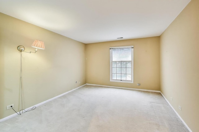 carpeted empty room with baseboards