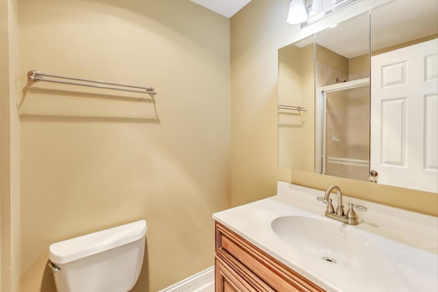 bathroom with vanity, toilet, and an enclosed shower