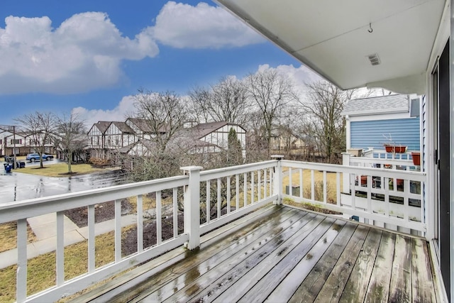 deck featuring a residential view and visible vents