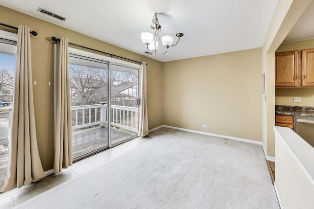 unfurnished dining area featuring light carpet, baseboards, visible vents, and a chandelier