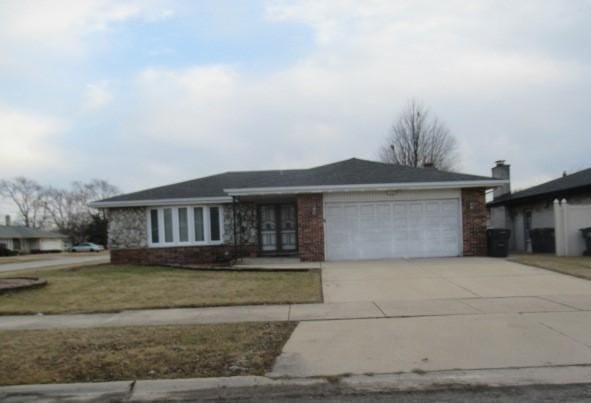 ranch-style home with a garage, concrete driveway, and a front lawn