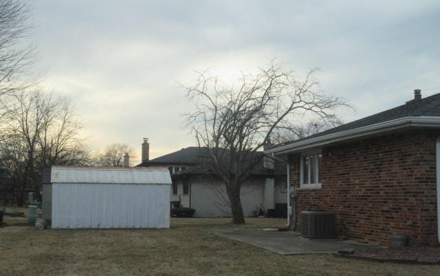 exterior space with cooling unit, an outdoor structure, and a shed