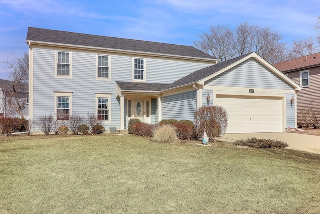 traditional-style home featuring driveway, a front yard, and an attached garage