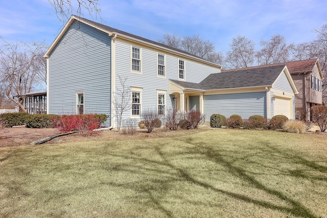 view of front of property with a front yard and a garage