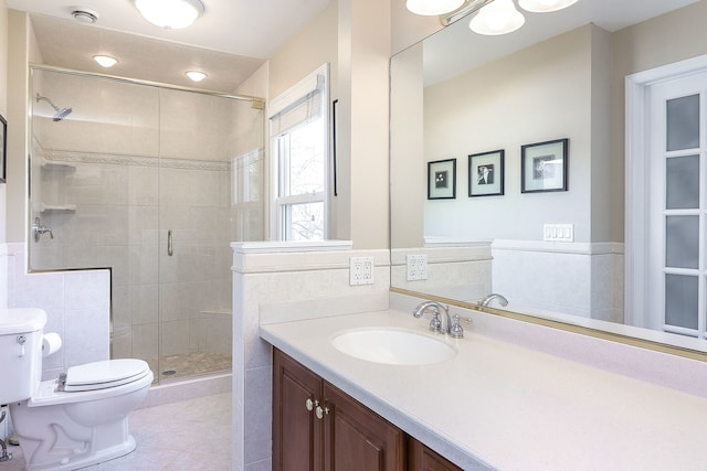 full bathroom featuring tile patterned floors, a stall shower, toilet, and vanity