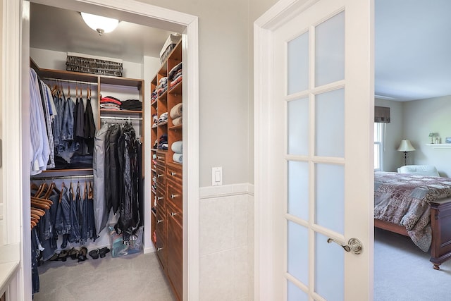 walk in closet with carpet