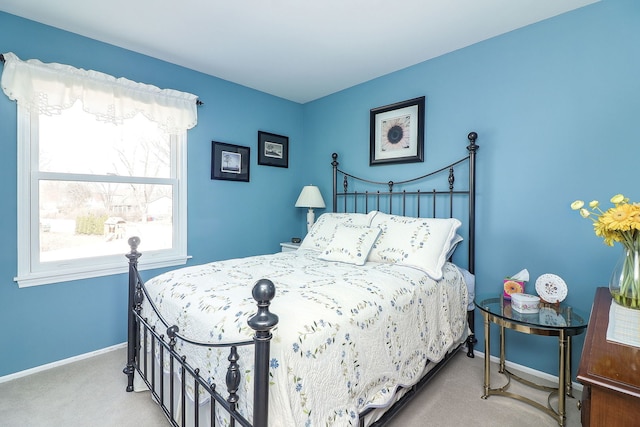 bedroom featuring baseboards and carpet