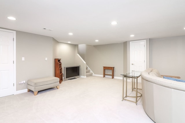 living room with light carpet, recessed lighting, stairs, and baseboards