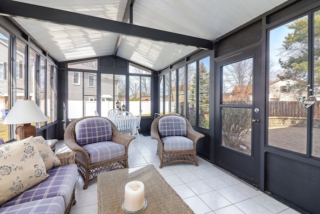 sunroom / solarium featuring vaulted ceiling with beams