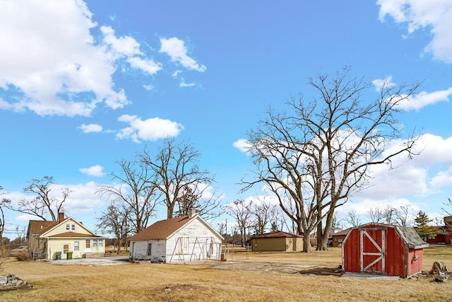 view of yard with a storage shed and an outbuilding