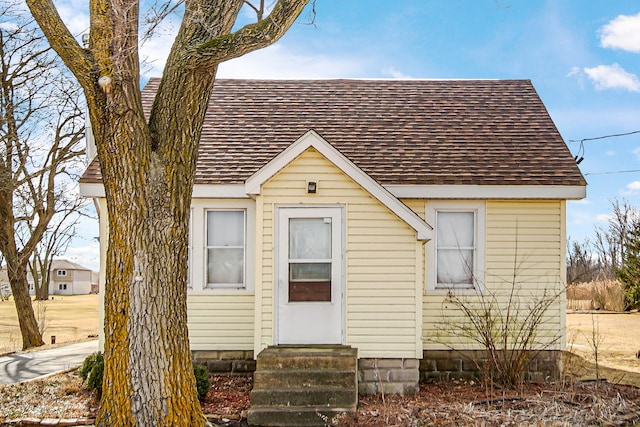 view of front of home featuring entry steps and roof with shingles