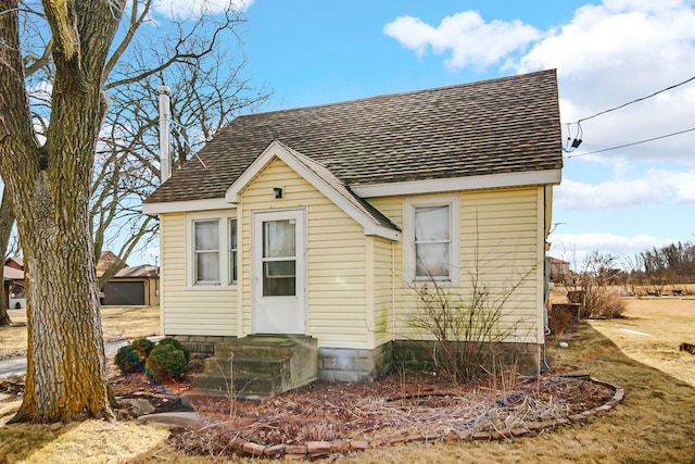 view of front of house with a shingled roof and entry steps