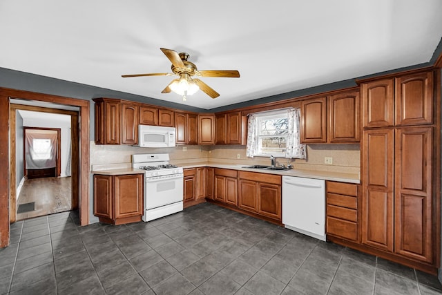 kitchen with white appliances, light countertops, a sink, and ceiling fan