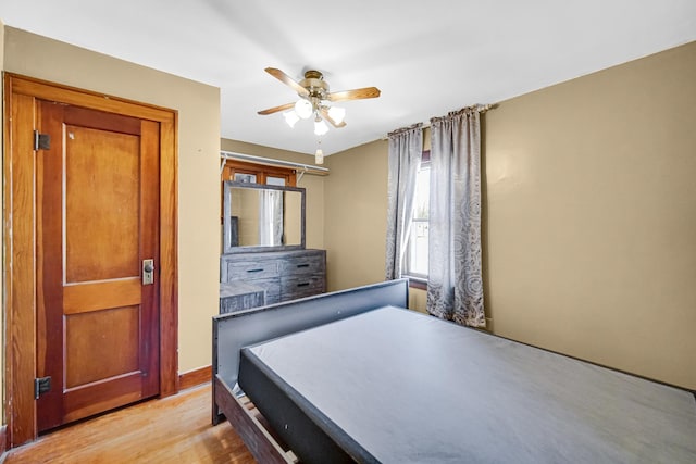 bedroom featuring light wood-type flooring and a ceiling fan