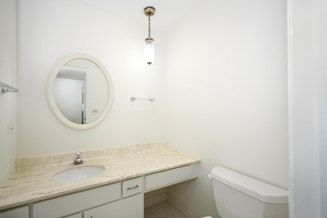 bathroom featuring toilet, tile patterned flooring, and vanity